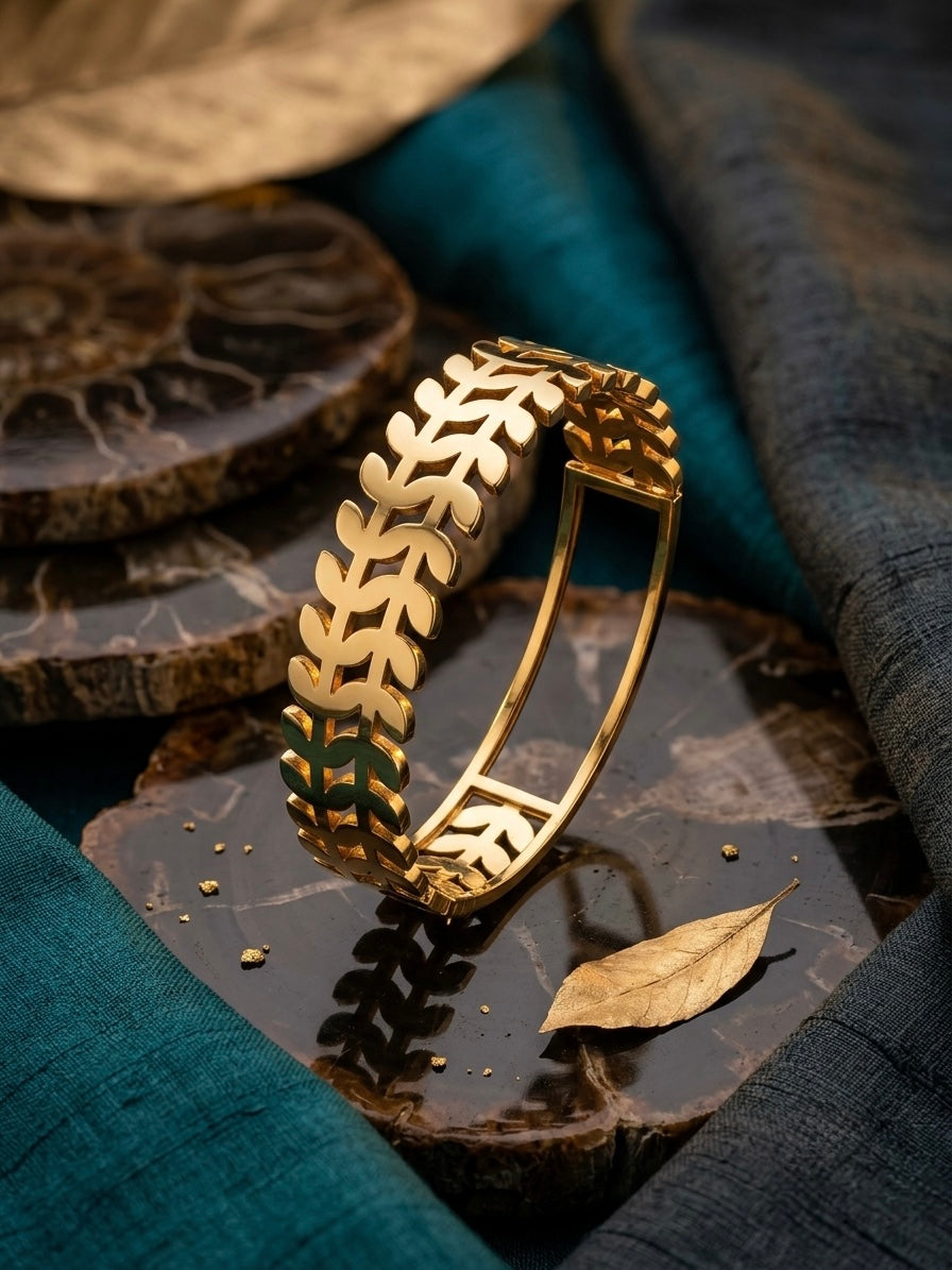 Nature-inspired polished gold leaf cuff.