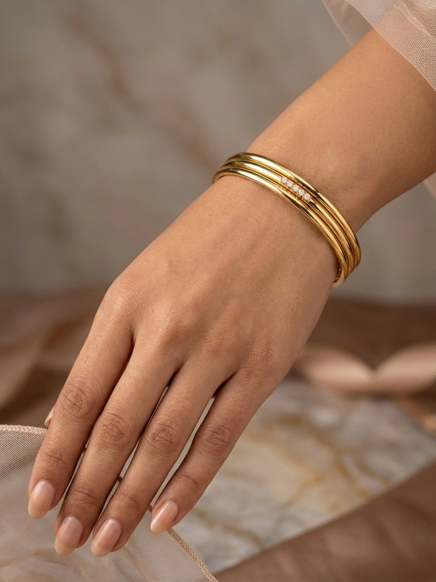 Sophisticated triple-ring gold statement bracelet.