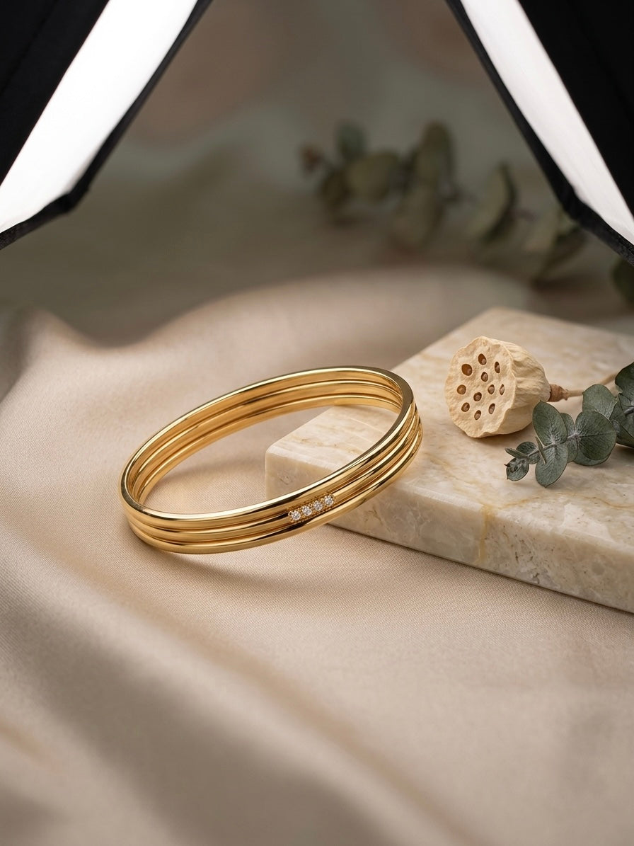 Sophisticated triple-ring gold statement bracelet.