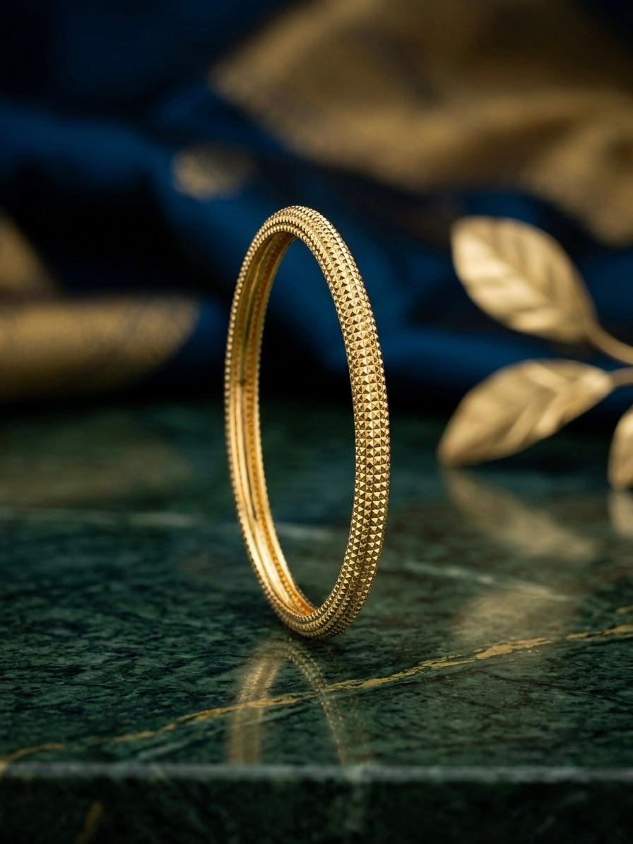 Shimmering geometric pattern gold kada.
