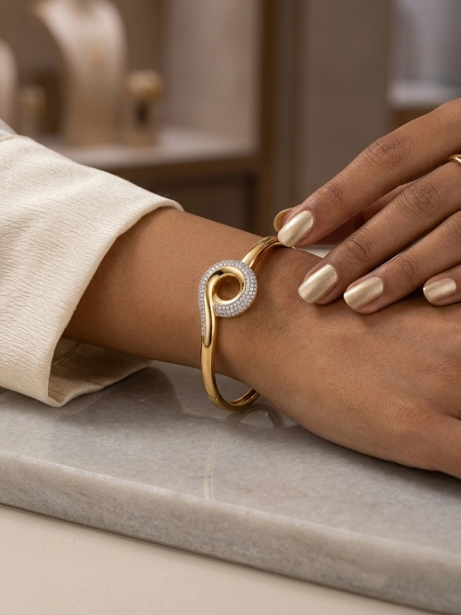 Sparkling twisted swirl gold bracelet.