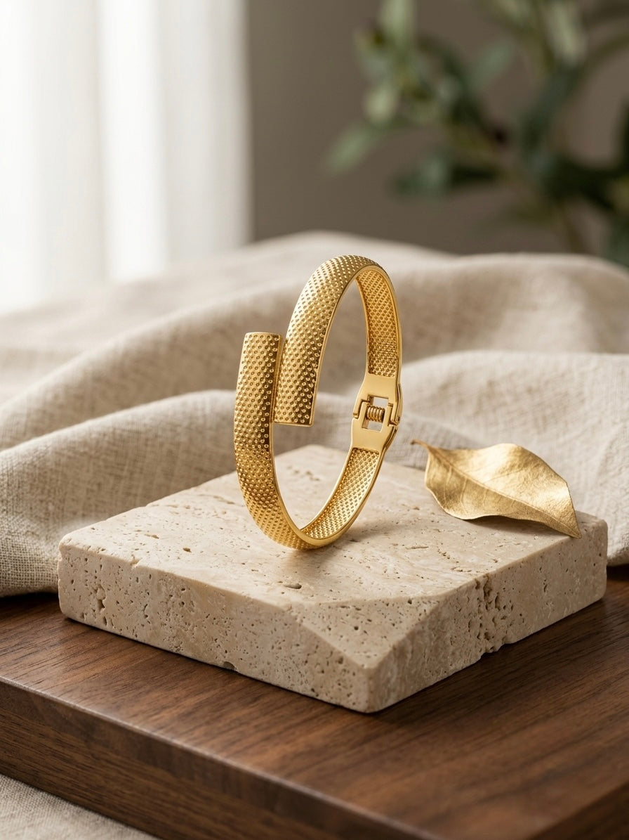 Modern textured overlap gold bracelet.