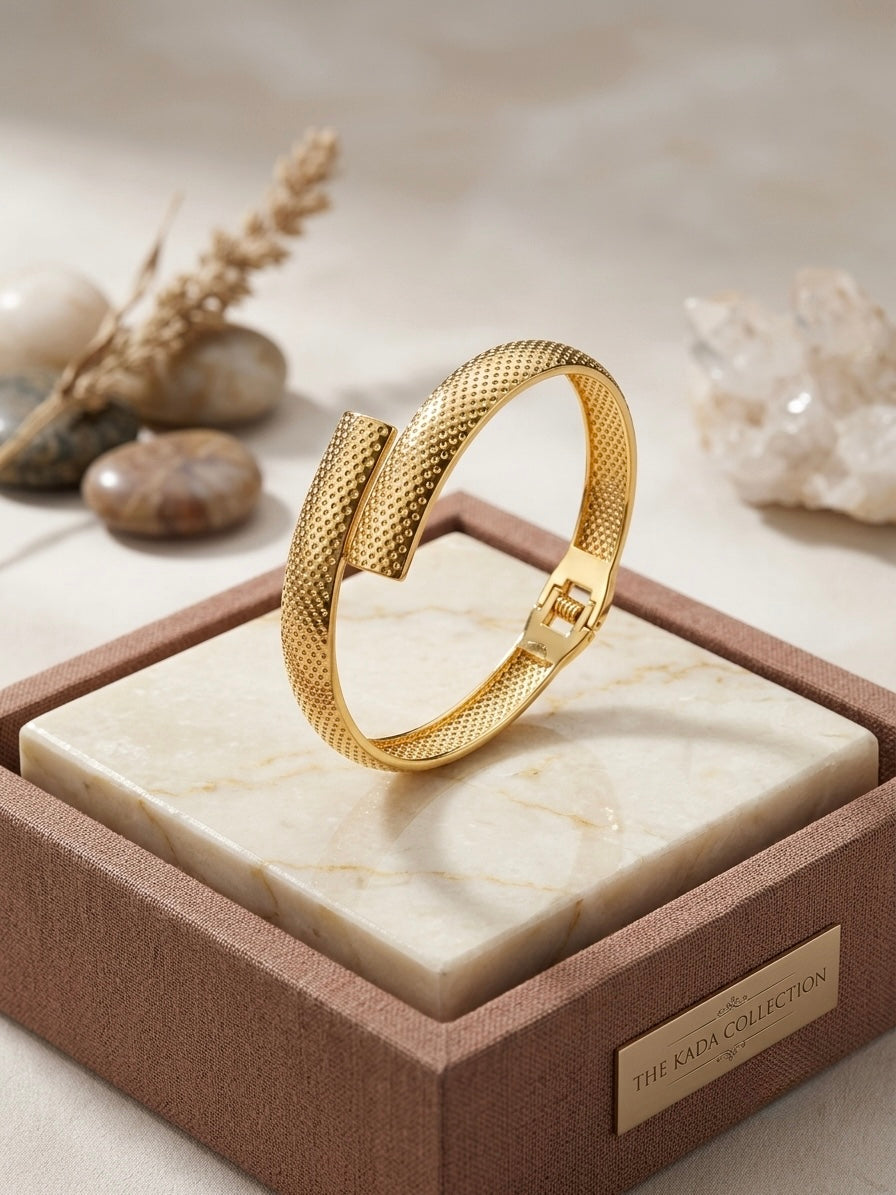 Modern textured overlap gold bracelet.