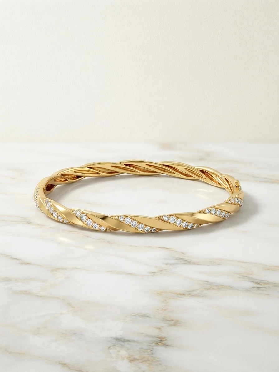 Elegant twisted diamond gold Kada bracelet.