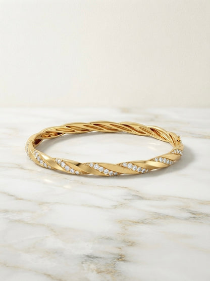 Elegant twisted diamond gold Kada bracelet.
