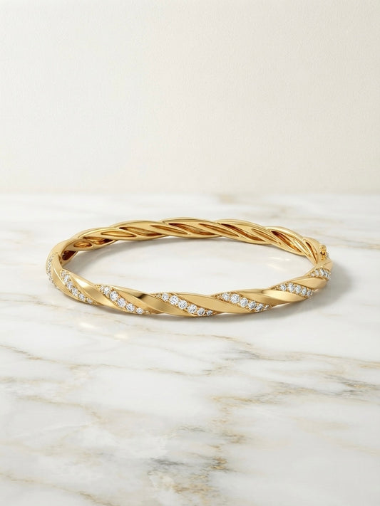 Elegant twisted diamond gold Kada bracelet.
