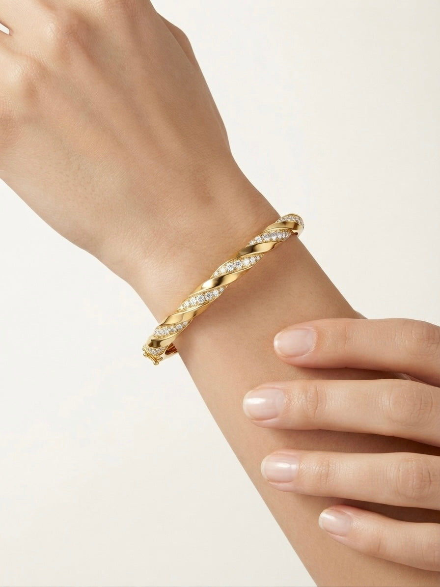 Elegant twisted diamond gold Kada bracelet.