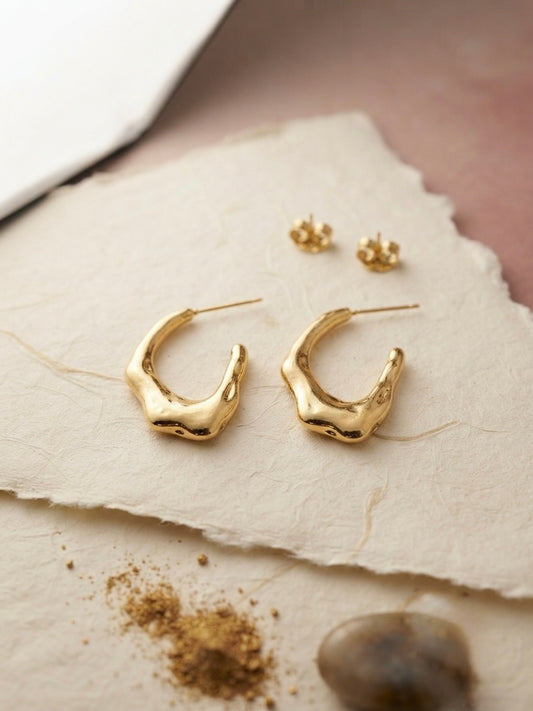 Sculptural molten gold texture statement hoops.