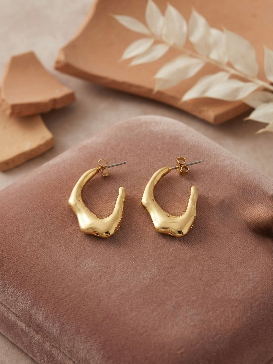 Sculptural molten gold texture statement hoops.