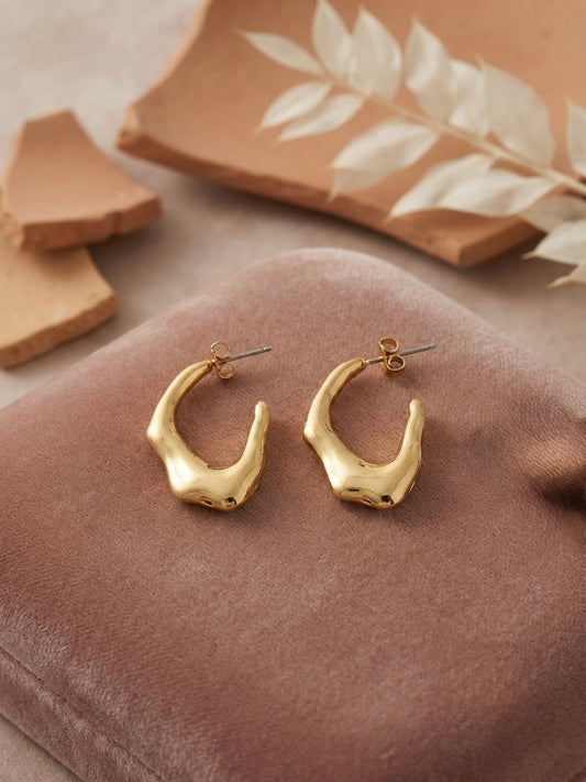 Sculptural molten gold texture statement hoops.