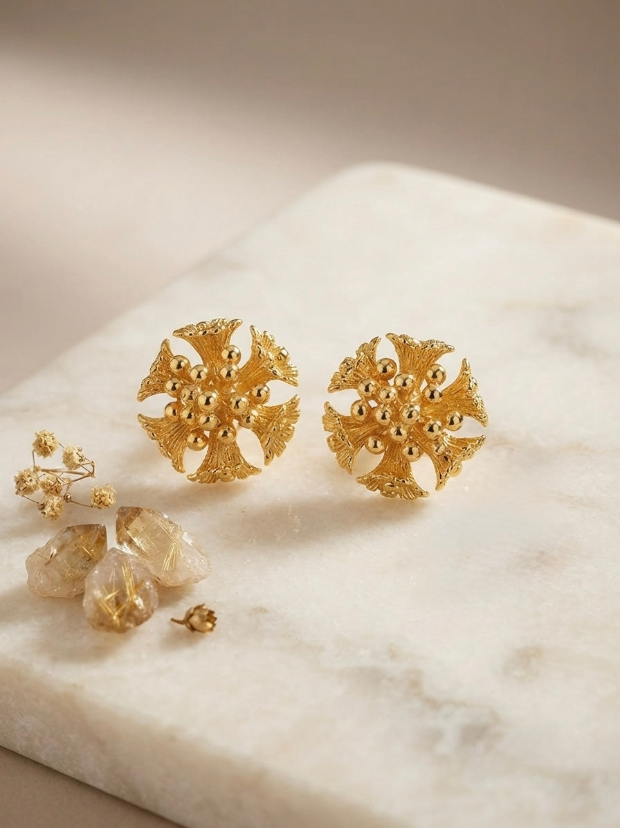 Intricate floral cluster gold stud earrings.