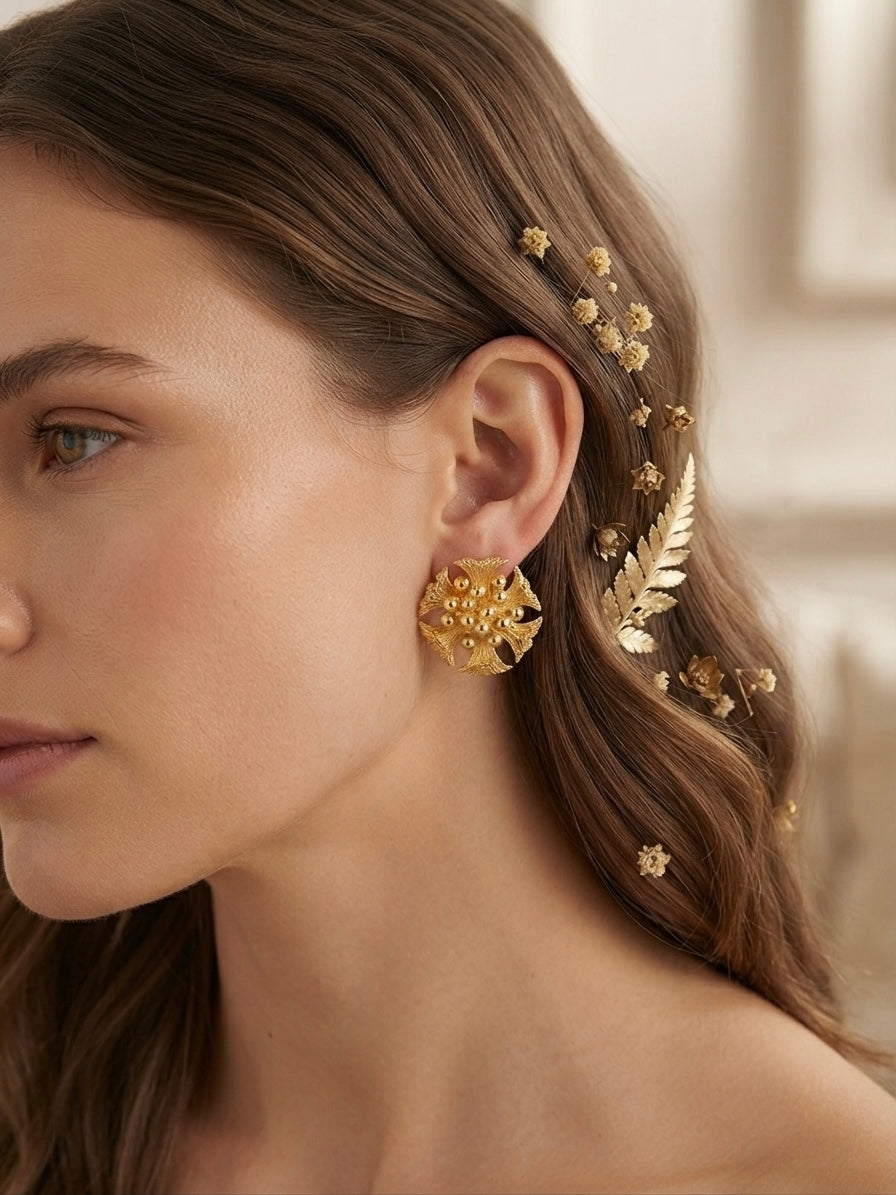 Intricate floral cluster gold stud earrings.