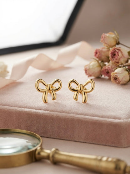 Charming polished gold bow stud earrings.