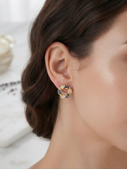 Intertwined gold moonstone and sapphire earrings.