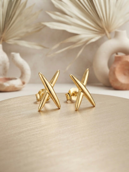 Modern geometric cross gold stud earrings.