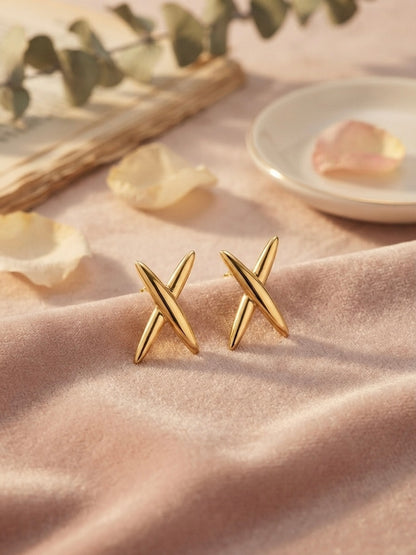 Modern geometric cross gold stud earrings.
