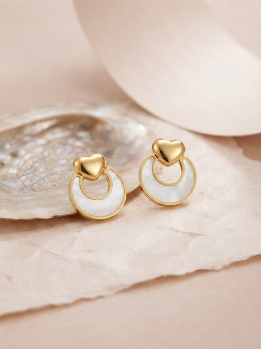 Gold heart and mother-of-pearl earrings.