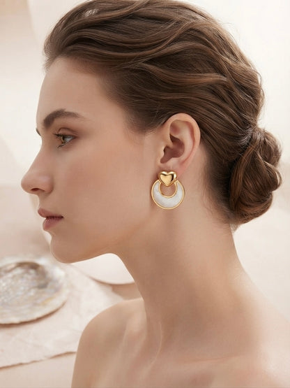 Gold heart and mother-of-pearl earrings.