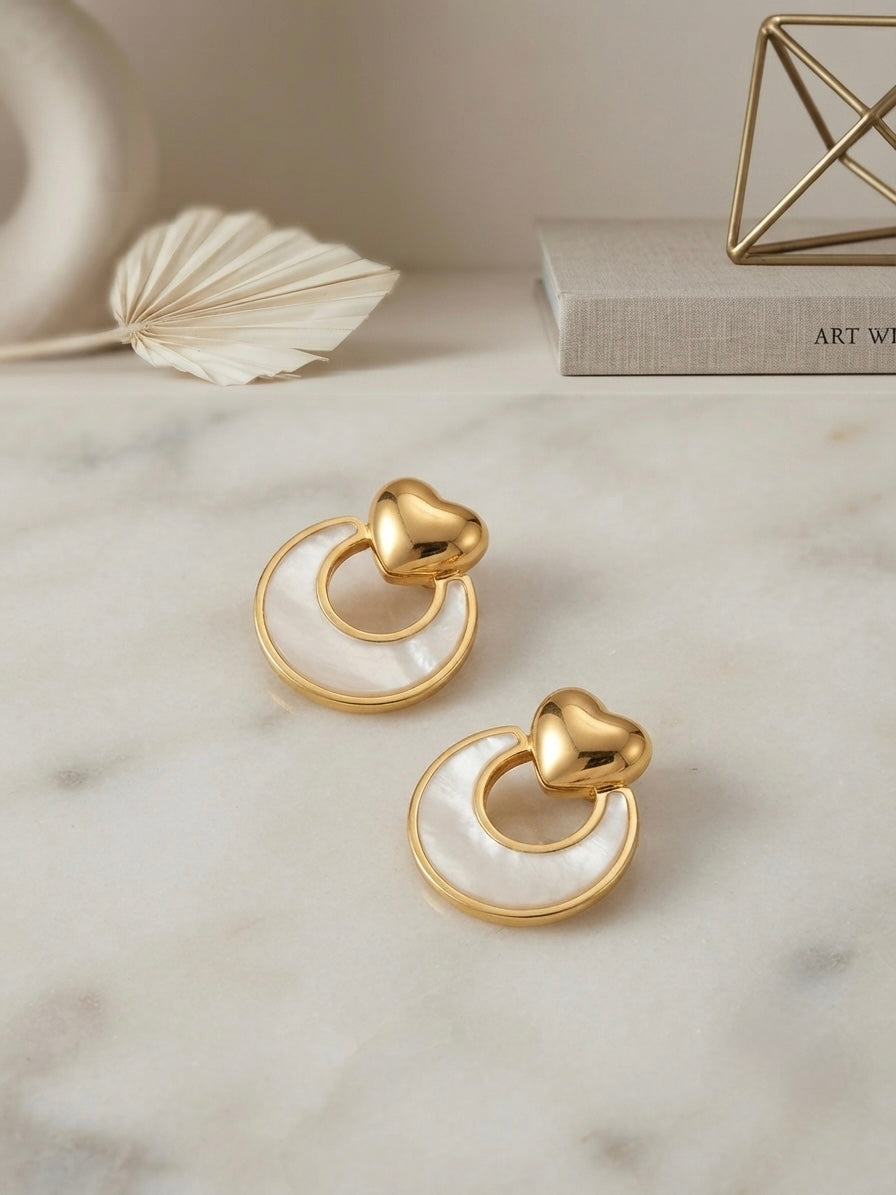Gold heart and mother-of-pearl earrings.