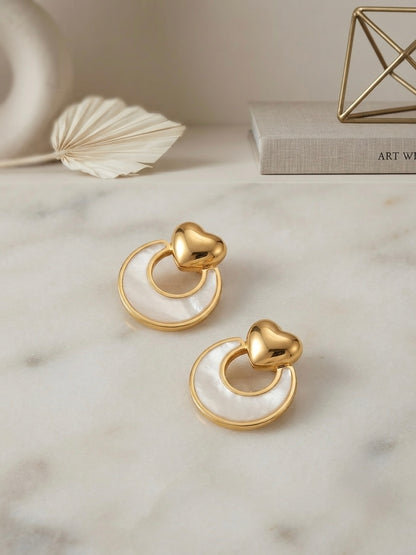 Gold heart and mother-of-pearl earrings.