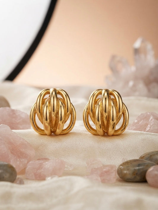 Interwoven golden cage statement earrings.