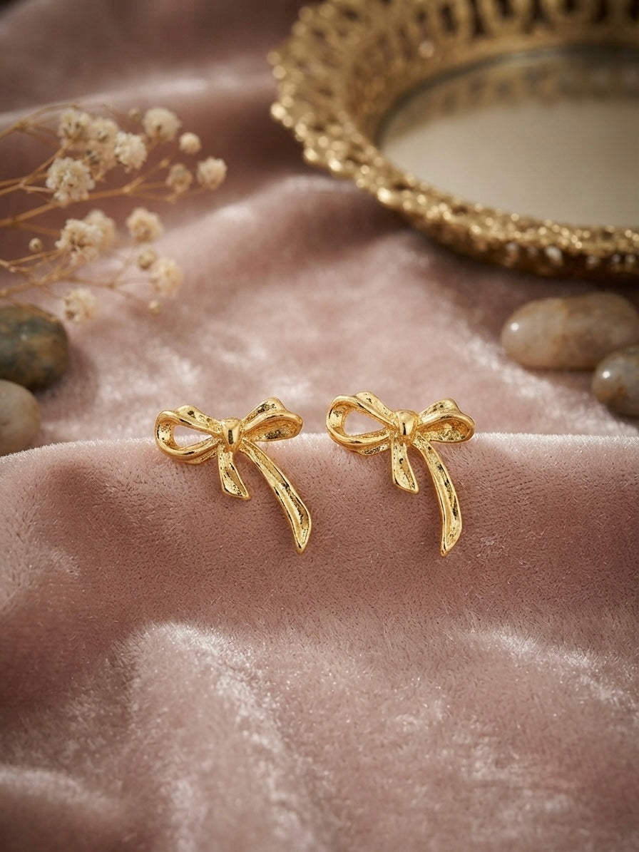 Textured gold ribbon bow earrings.