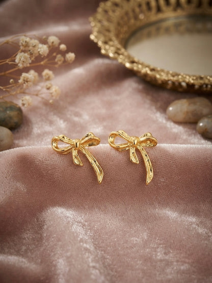 Textured gold ribbon bow earrings.