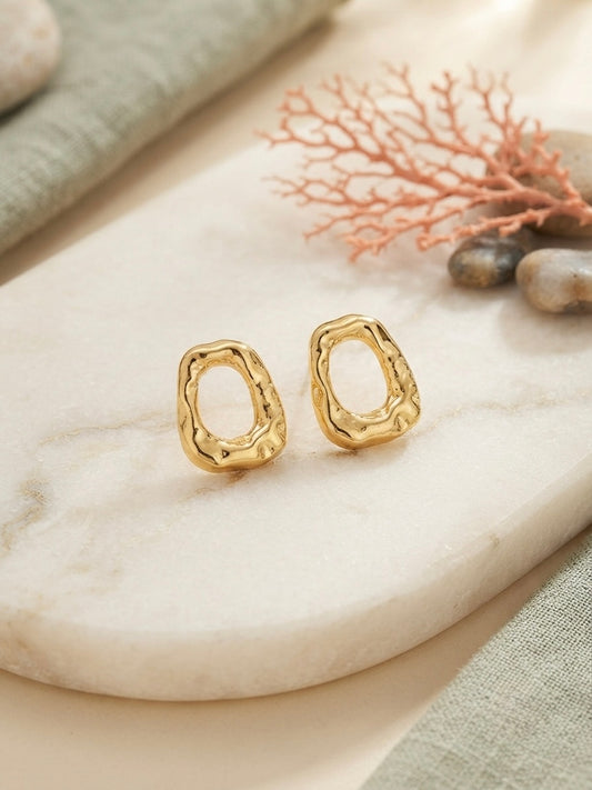 Organic molten gold oval hoop earrings.