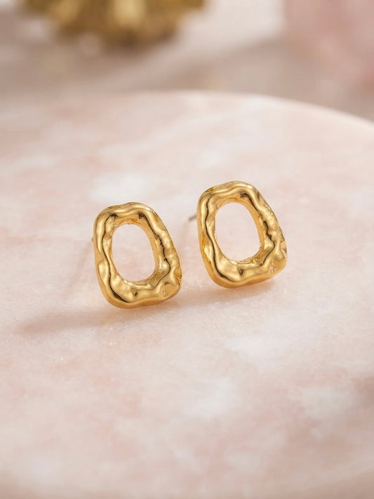 Organic molten gold oval hoop earrings.