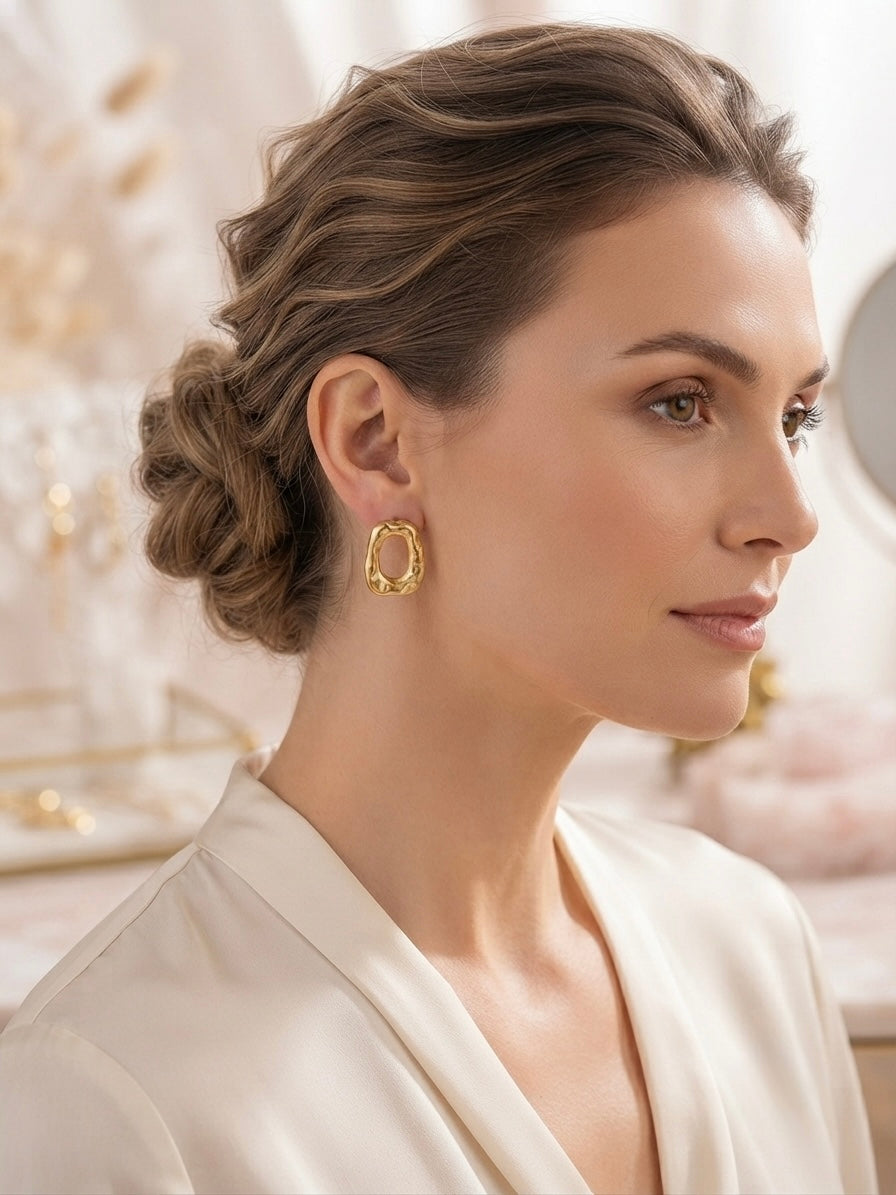 Organic molten gold oval hoop earrings.