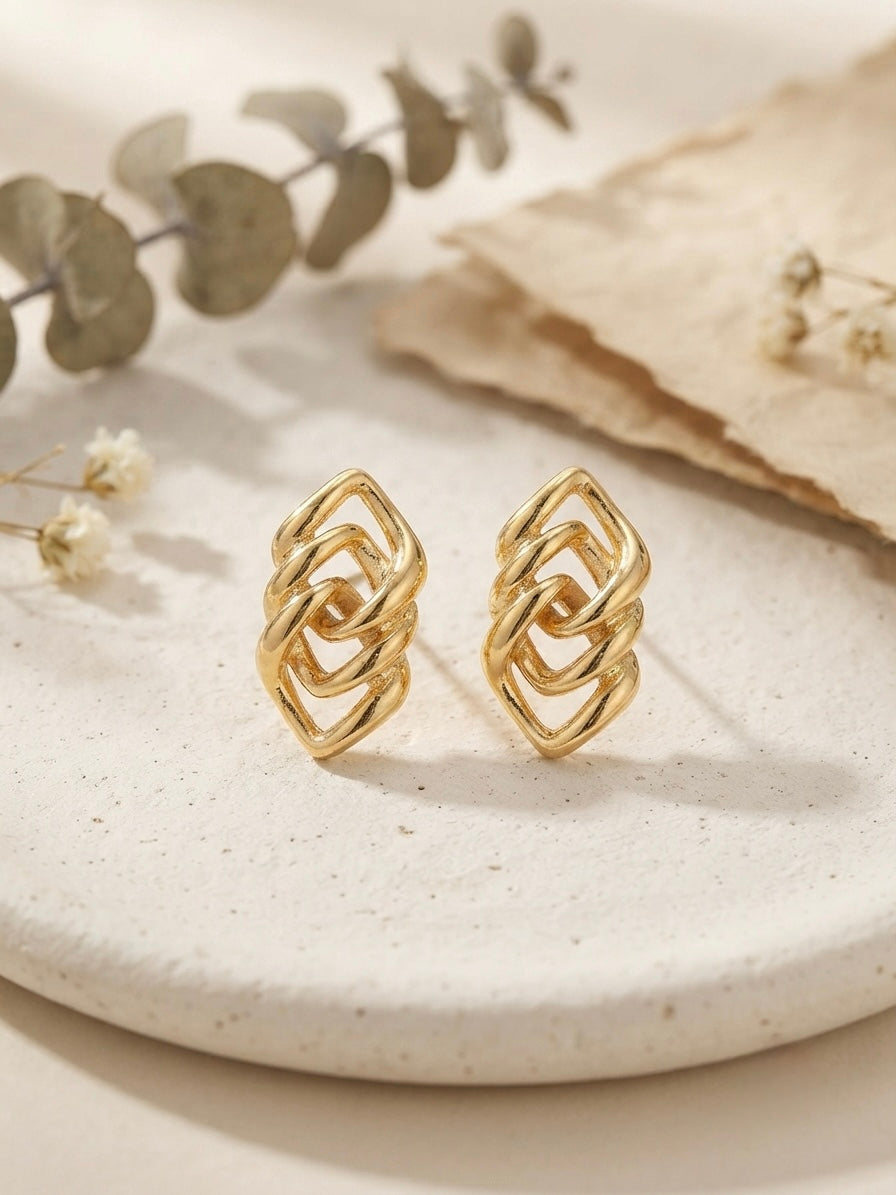 Geometric interlocking gold lozenge earrings.