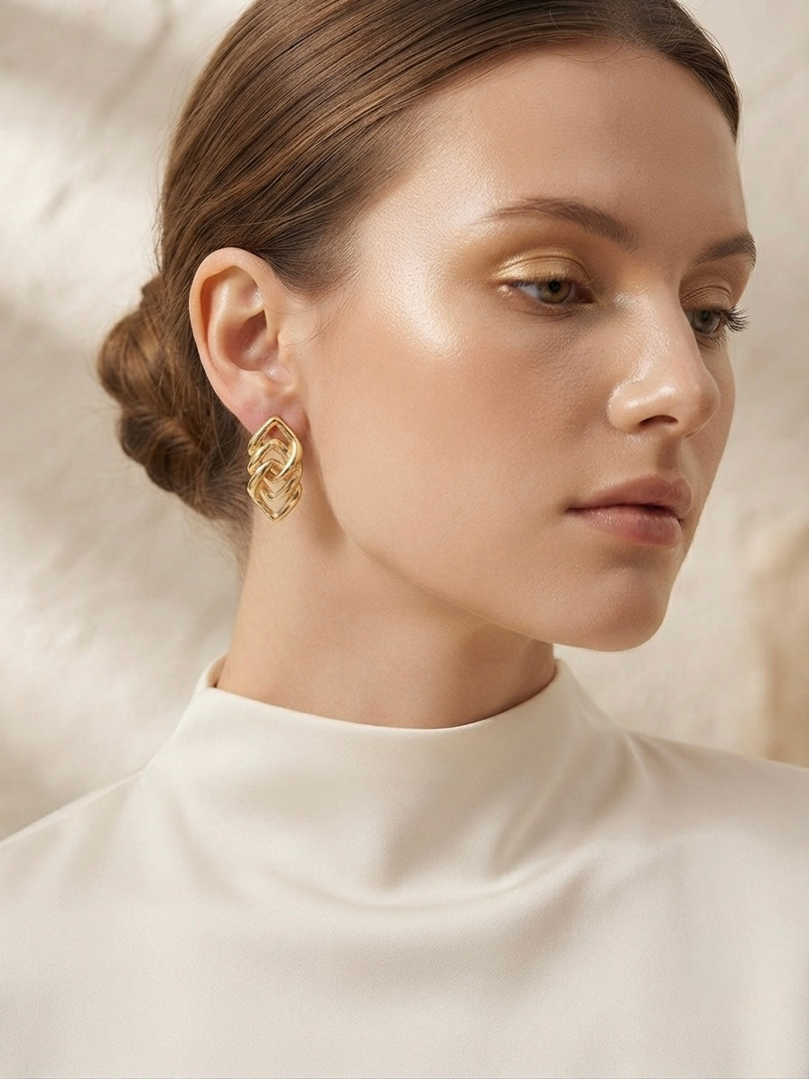 Geometric interlocking gold lozenge earrings.