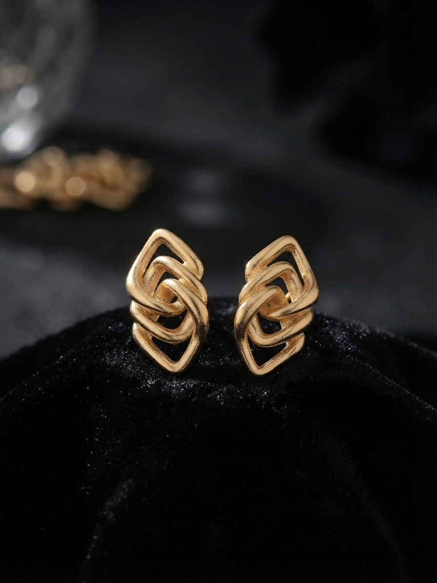Geometric interlocking gold lozenge earrings.