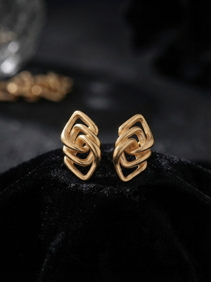Geometric interlocking gold lozenge earrings.