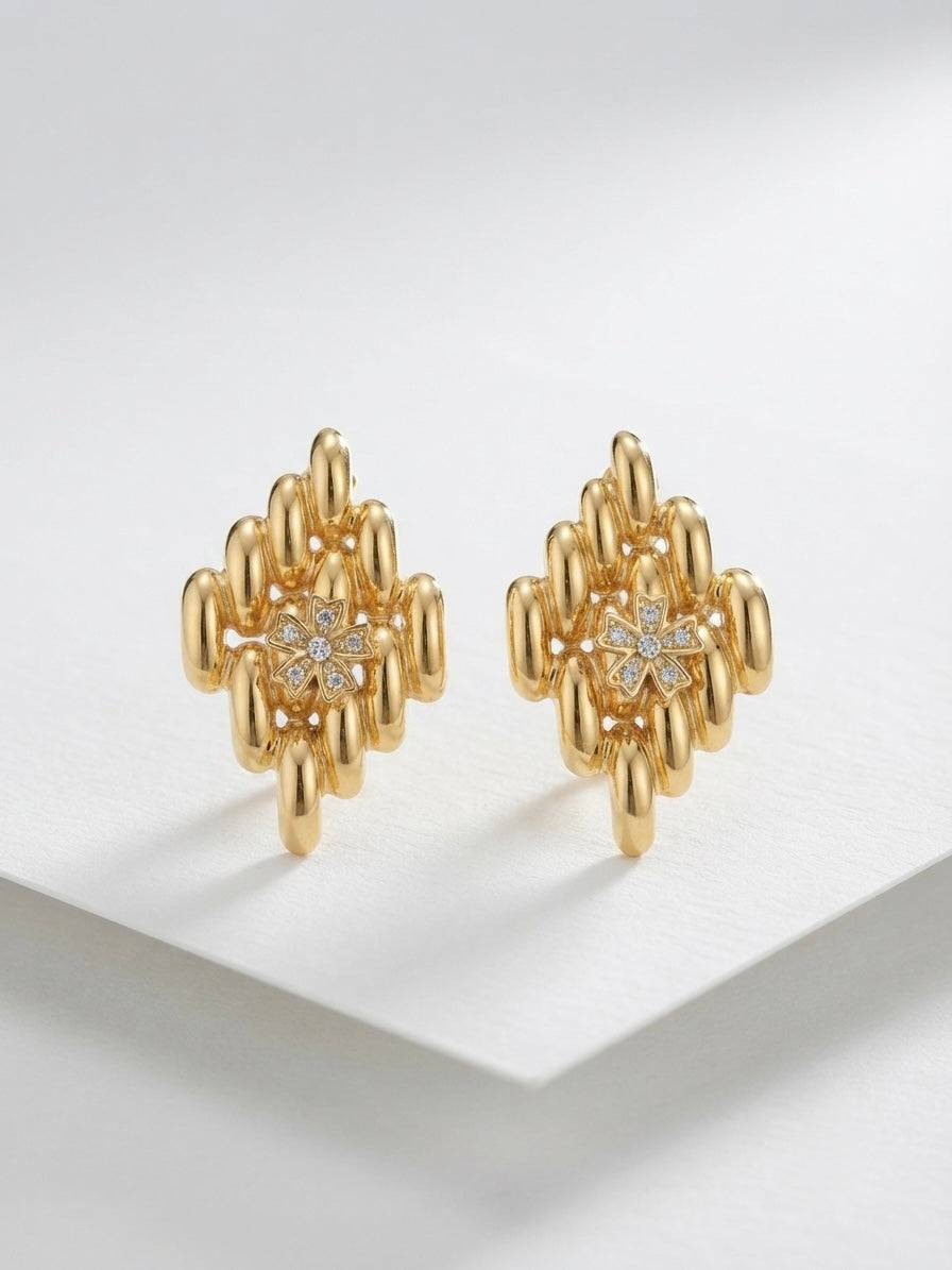 Sculpted geometric gold cluster statement studs.