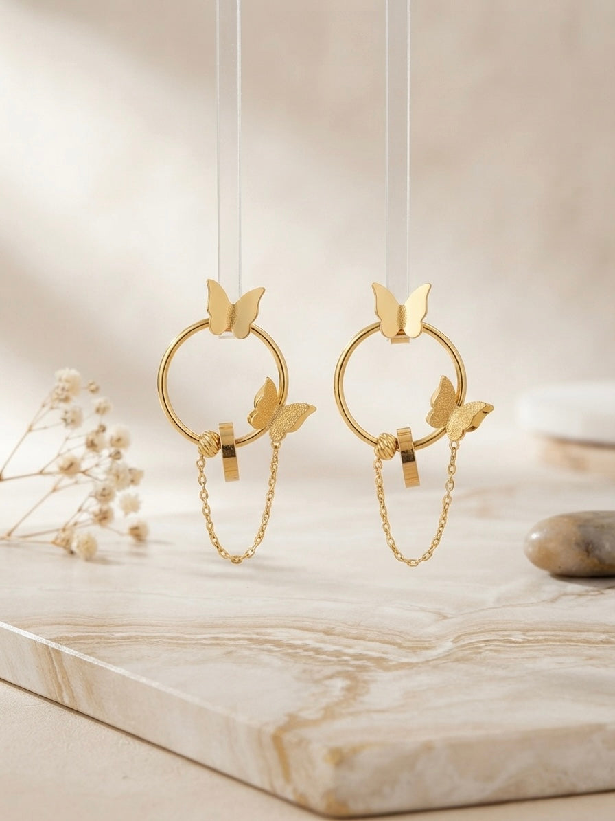 Gold butterfly hoop drop chain earrings.