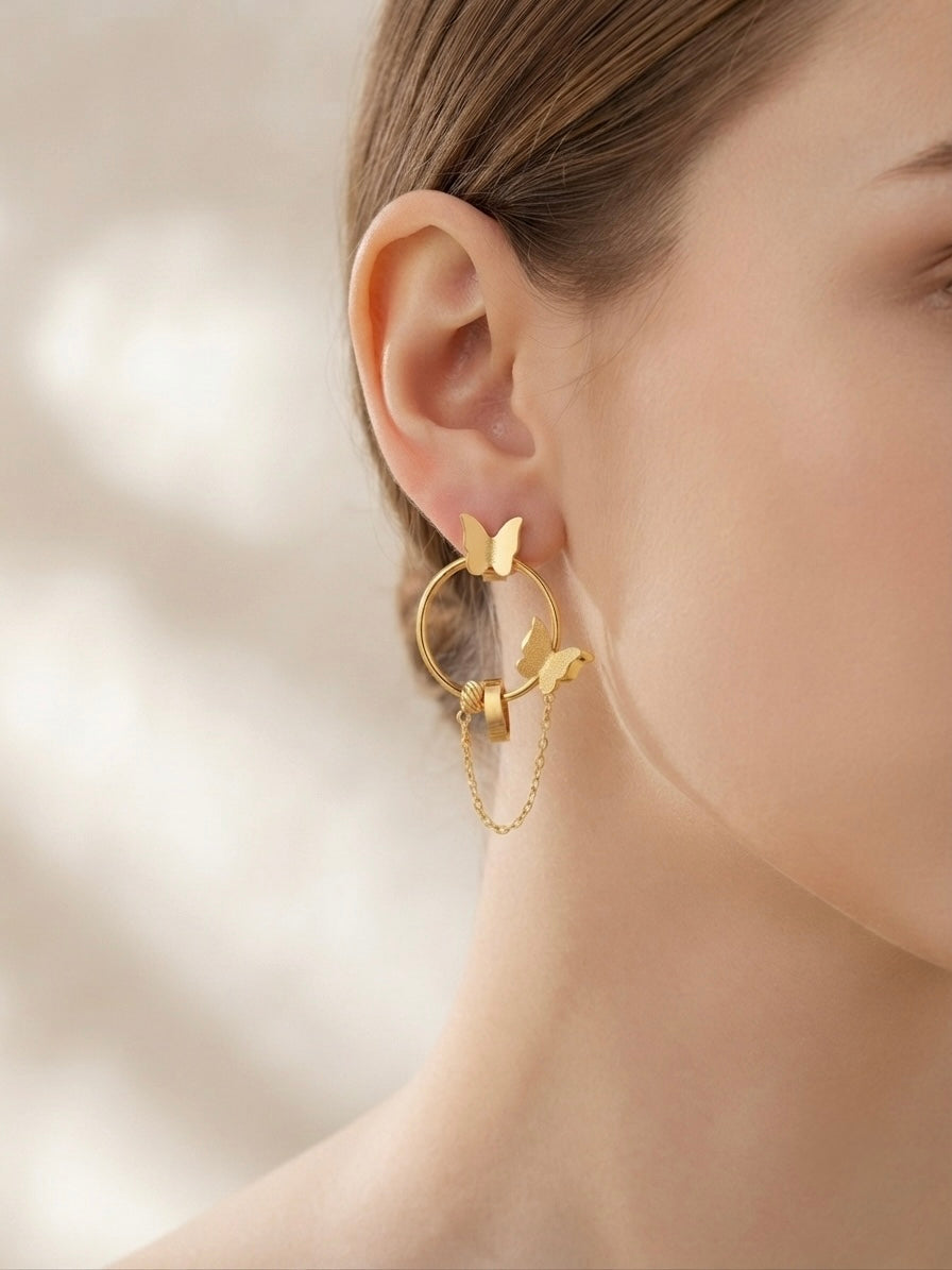 Gold butterfly hoop drop chain earrings.