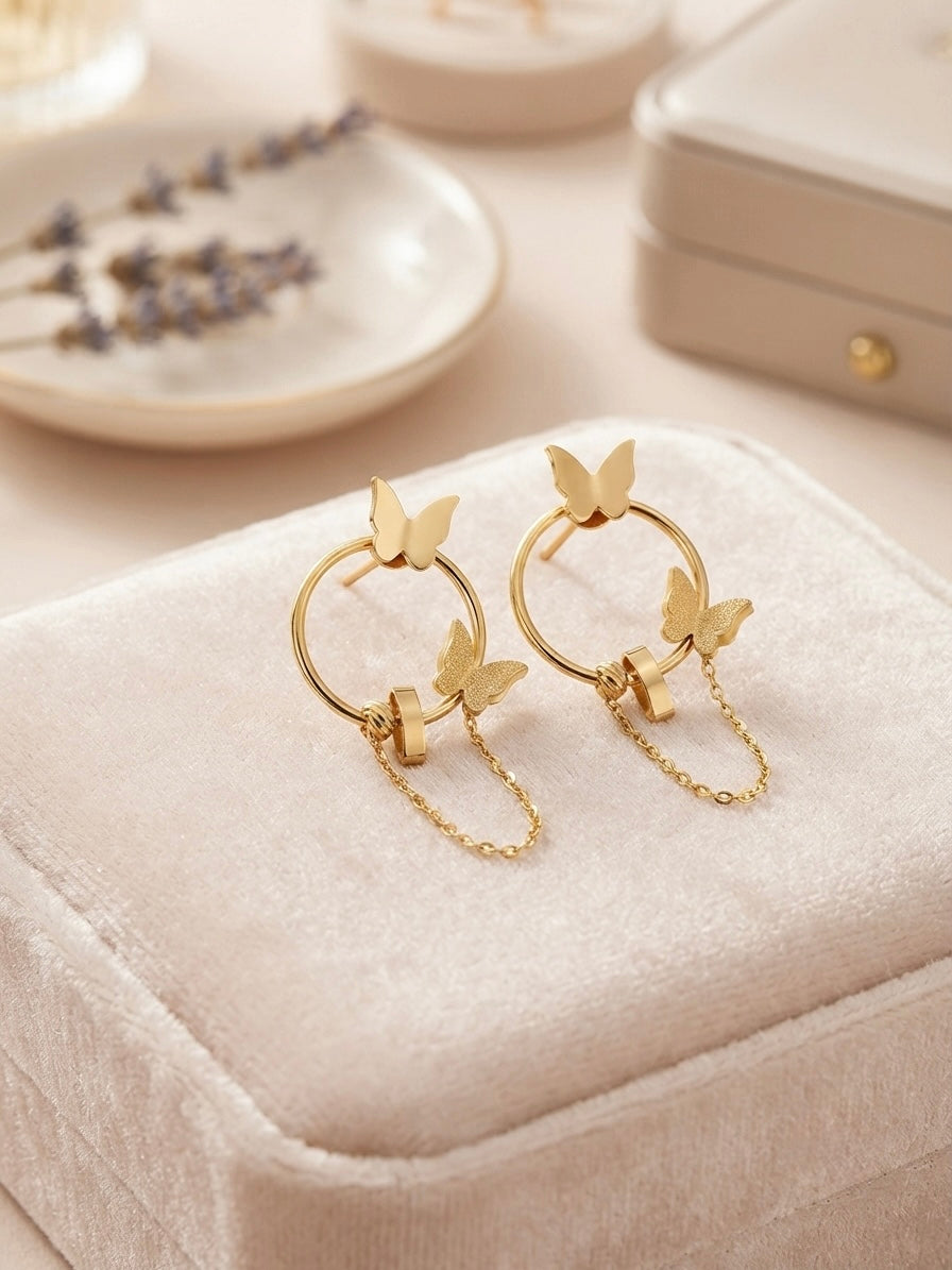 Gold butterfly hoop drop chain earrings.