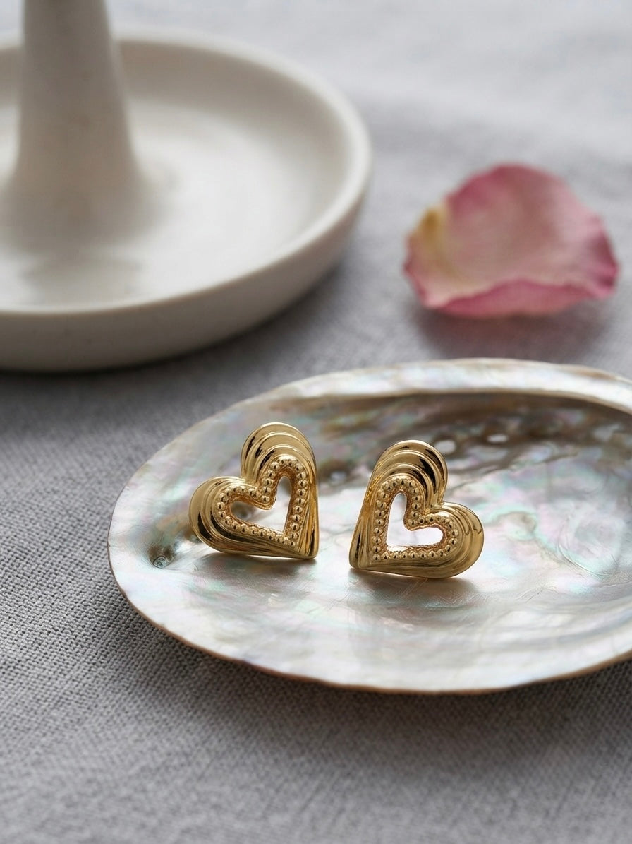 Textured beaded gold heart stud earrings.