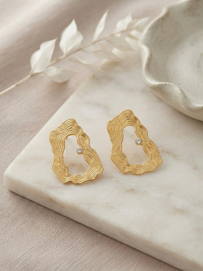 Textured wavy gold crystal hoop earrings.