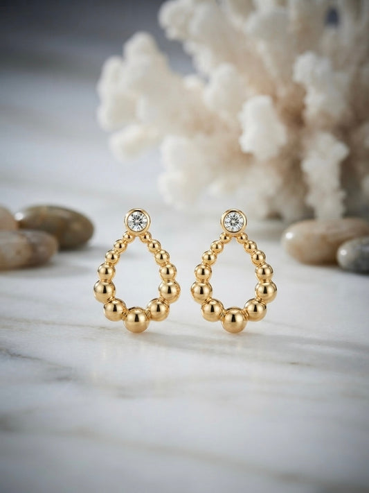 Sparkling bezel crystal gold drop studs.
