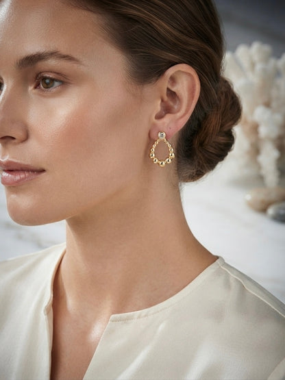 Sparkling bezel crystal gold drop studs.