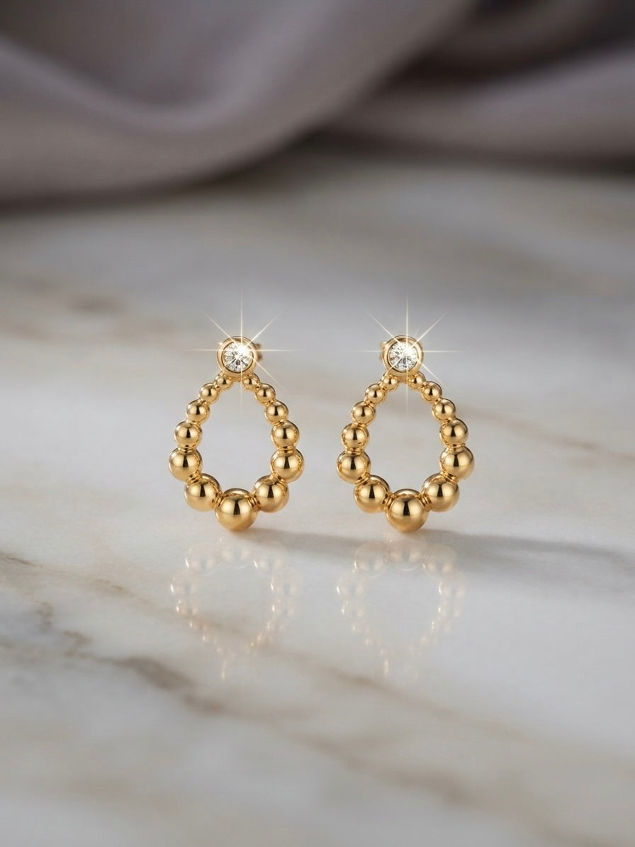 Sparkling bezel crystal gold drop studs.