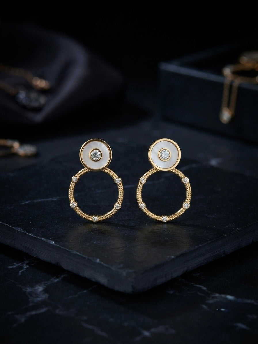 Circular mother-of-pearl and crystal studs.