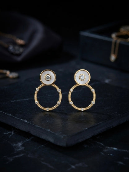 Circular mother-of-pearl and crystal studs.