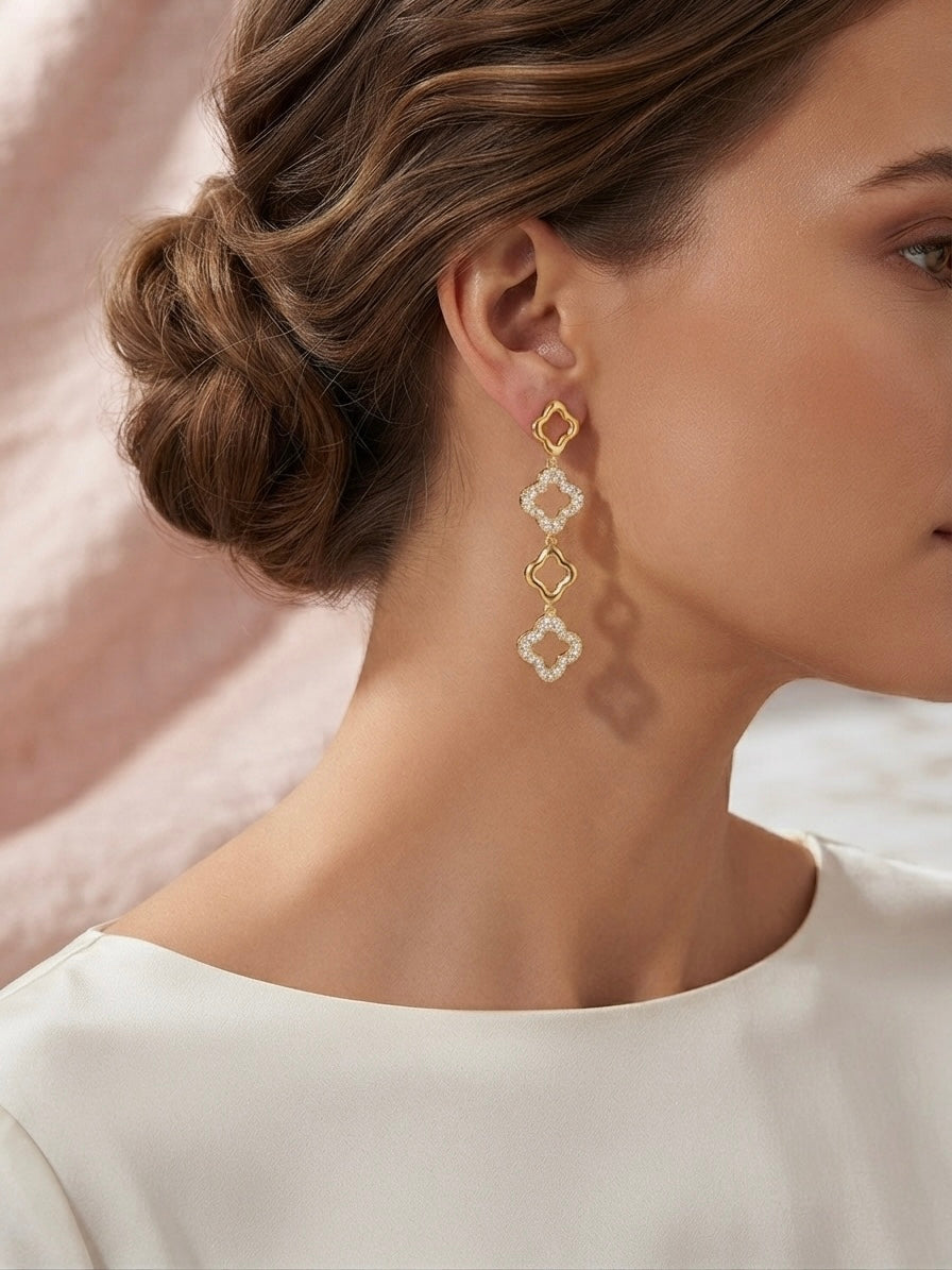 Alternating crystal and gold clover dangles.