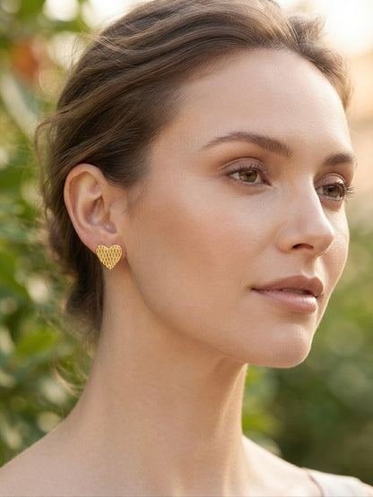 Textured honeycomb pattern gold heart studs.