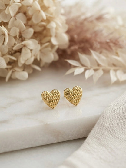 Textured honeycomb pattern gold heart studs.