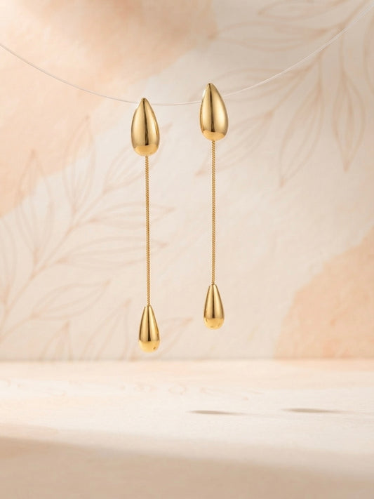 Sleek polished gold teardrop chain earrings.