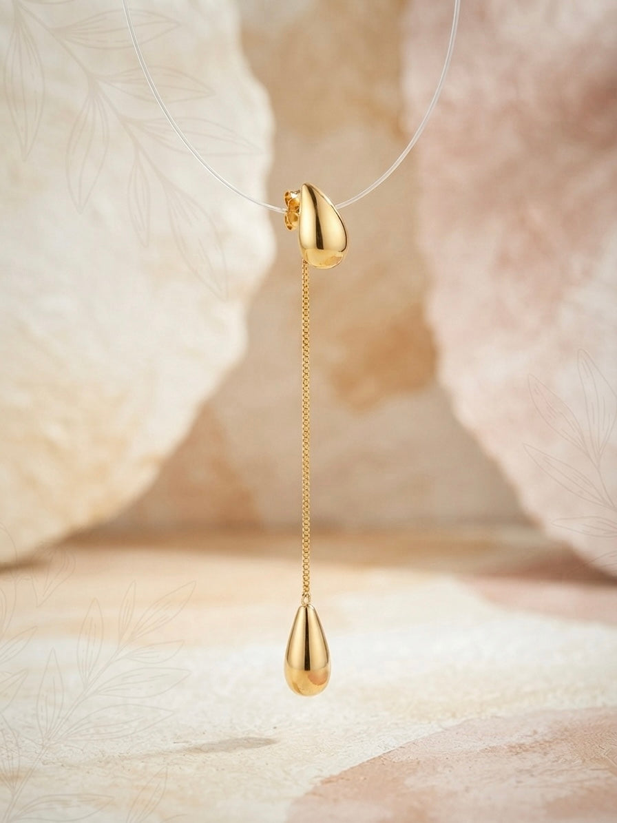 Sleek polished gold teardrop chain earrings.